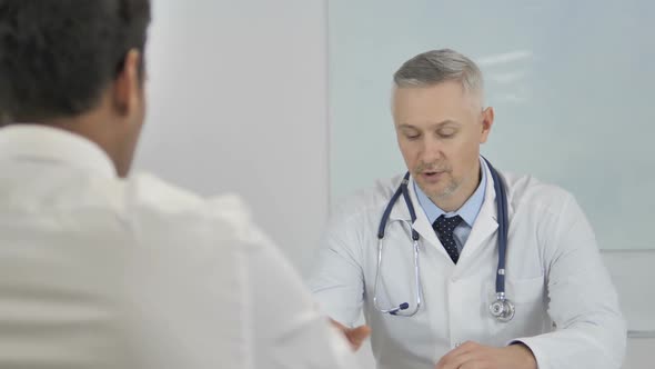 Senior Doctor Advising Patient Helping with Health Issues