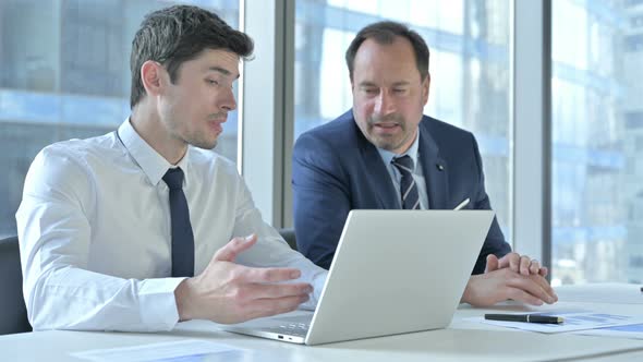 Disappointed Businessmen Get Shock While Working on Laptop