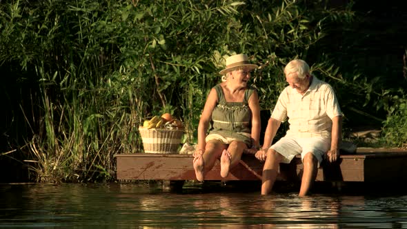 Old Woman Kissing Man Near Water.