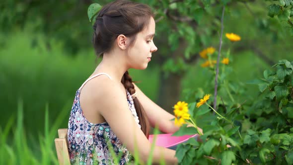 Young Girl Eating Berries in Garden.