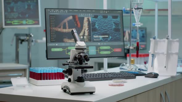 Microscope on Laboratory Desk with Medical Research Equipment