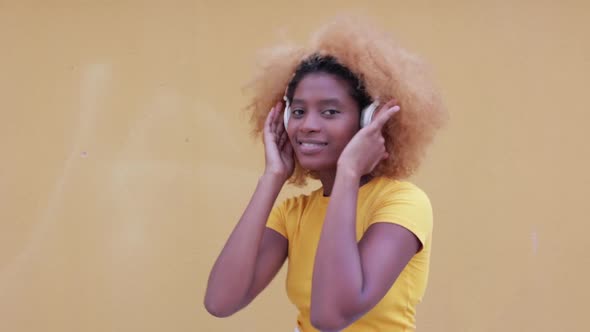 Happy Afro American Having Fun and Dancing While Listening Music with Headphones