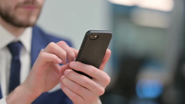 Close Up of Hands of Businessman Using Smartphone