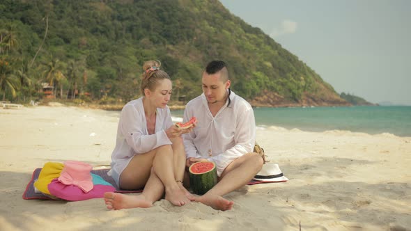 The Cheerful Love Couple Holding and Eating Slices of Watermelon on Tropical Sand Beach Sea