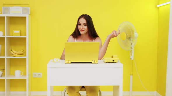 Woman Is Communicating Online In Yellow Office