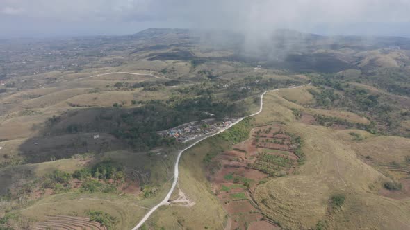 Panoramic Drone Shot of Foggy Skies and Lush Green Hills in Bali, Indonesia