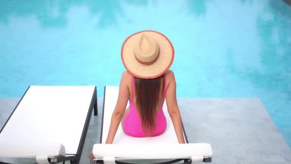 Young asian woman enjoy around outdoor swimming pool for leisure