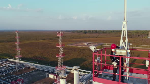 Dangerous Work at Heights An Installer Performs Work on a High Metal Tower