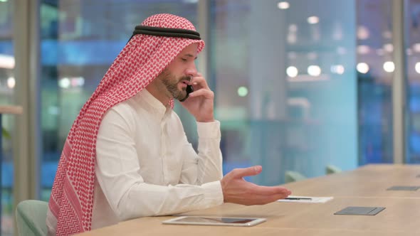 Arab Businessman Celebrating Success on Smartphone