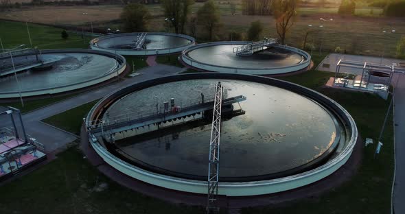 Aerial view of sewage treatment plant, camera moving along.