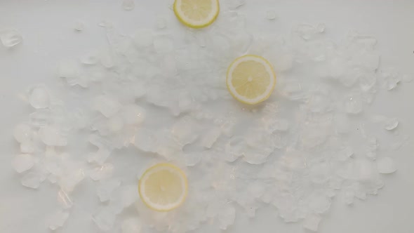 Lemon Slice Fall with Ice Cube on White Background