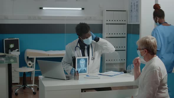 Black Doctor Holding Digital Tablet with x Ray Scan