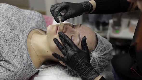 Cosmetologist Applies Peeling Lotion on Woman Face in Beauty Clinic Salon