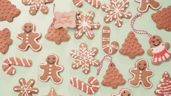 Traditional home made gingerbread cookies as food gifts on blue background with Christmas light.