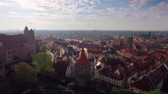 Aerial Rising City with A Castle in The Foreground at Beautiful Sunrise