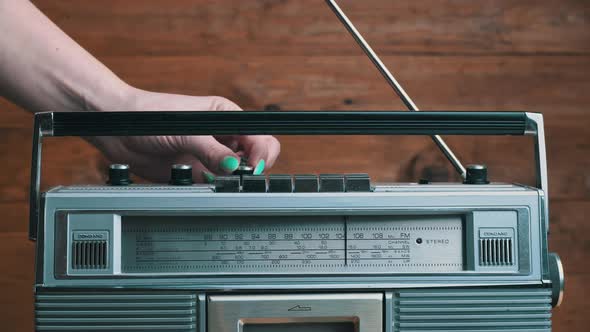 Girl's Hand Twists and Presses the Buttons on the Retro Radio Tape Recorder