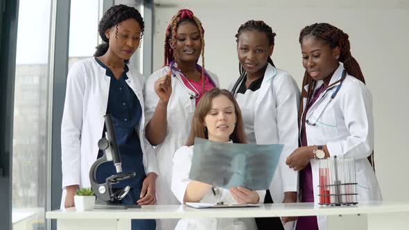 Young Doctors Examine an Xray While Standing at a Table