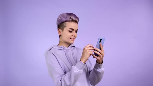 Young Woman in Purple Scrolling Text Social Media Browsing Internet
