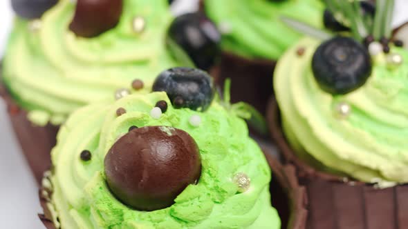 Extreme Close Up Rotating Cupcakes with Whipped Cream Decorate Berry