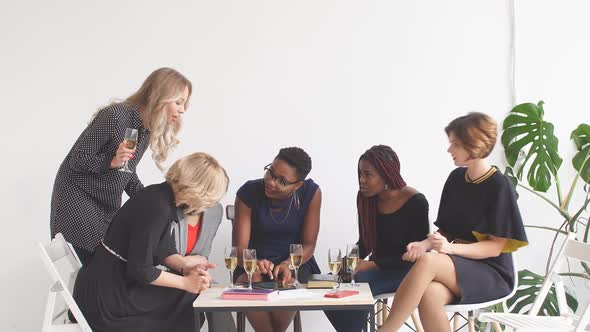 Happy Business Ladies Celebrate with Champagne at Office Meeting