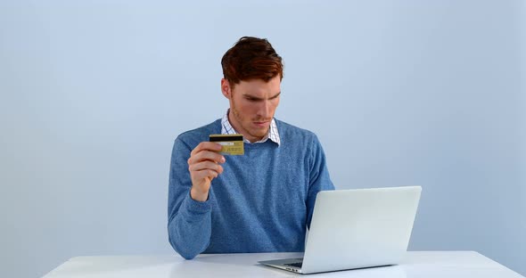 Man with credit card making transaction on laptop 4k