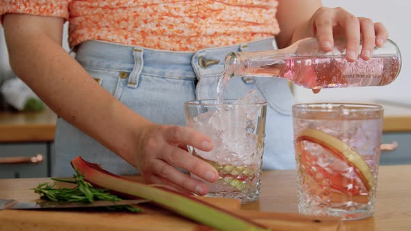 Young Woman Making Cocktail at Home Kitchen