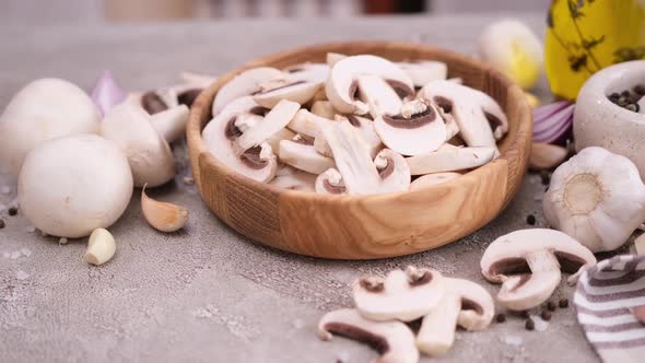 Sliced and Chopped Champignon Mushrooms in Wooden Bowl