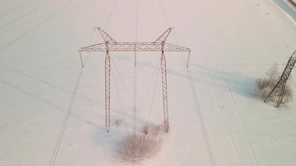 ABOVE VIEW Power Pylons in a Field in Winter