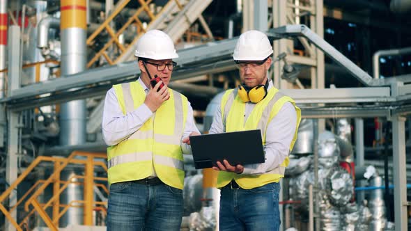 Engineers are Discussing the Oil Refinery Plant