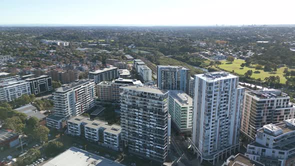 Aerial view of apartment complexes. Drone fly high over the neighborhood buildings on a sunny day.