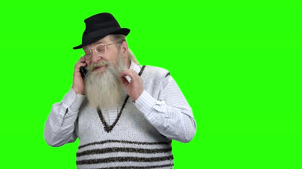 Positive Old Man in Hat Talking on Phone