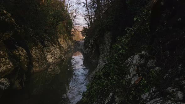 Flying Over a River Through a Narrow Canyon with White Rocks Sochi