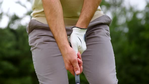 Young golfer hitting golf ball on a course