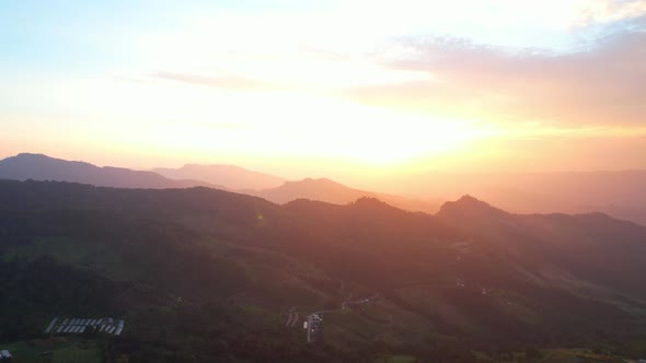 4K Aerial view of Rural village in the mountains. beautiful sunset over high mountains