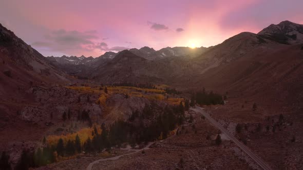 Cinematic View of Scenic Pink Sunset Sky Above the High Summit Snowy Peaks