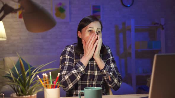 Young Girl Watching Shocking Content on Laptop Sitting in Her Modern Apartment