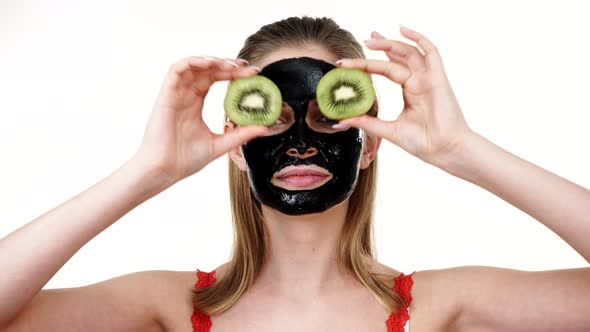 Girl Black Mask on Face Holds Kiwi Fruit