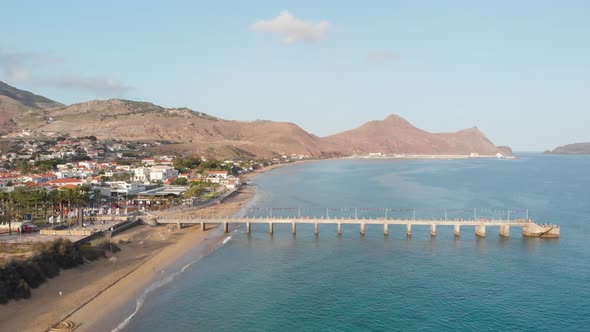 Aerial of the Porto Santo beach with a bridge leading out into the water.