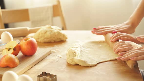 Closeup of Female Hands Rolling Out Cookie Dough Pizza