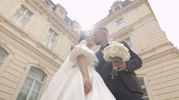 Newlyweds Portrait Caucasian Groom Bride Walking Embracing Hugs Near Old Castle Wedding Couple