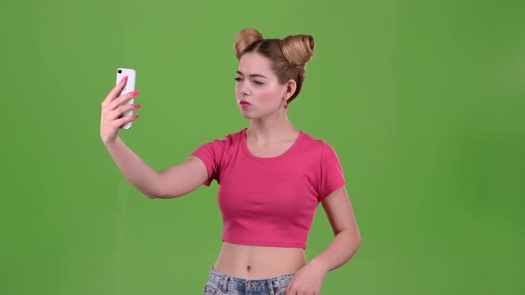 Girl Doing Selfie. Green Screen. Slow Motion