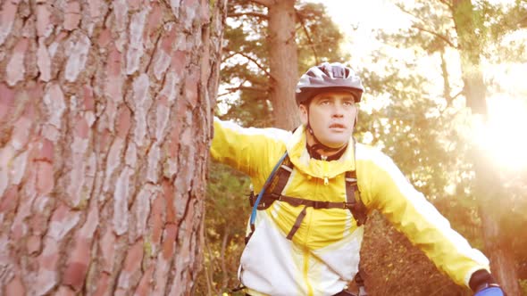 Male mountain biker taking a break and looking at nature