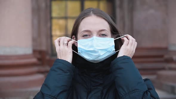 Young Woman Takes Off Medical Mask and Smile