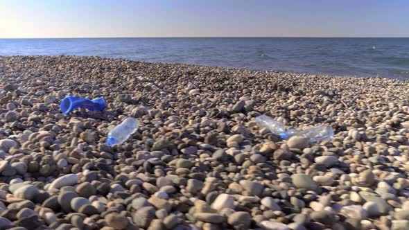 large amount of plastic garbage litters ocean shore.
