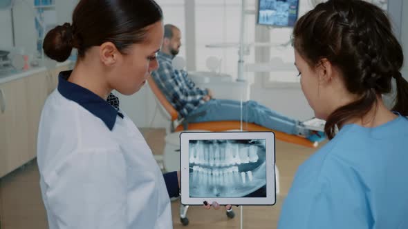 Stomatologist Holding Modern Tablet with x Ray on Screen