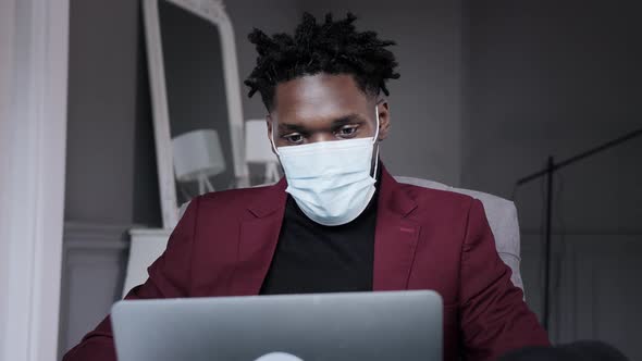 a Black Man Works at a Laptop Closeup of His Face