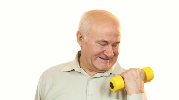 Happy Old Man Showing Thumbs Up Working Out with a Dumbbell