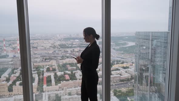 Silhouette of a Business Woman on a Background of the City