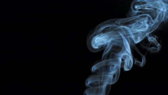 Abstract Smoke Rises Up in Beautiful Swirls on a Black Background