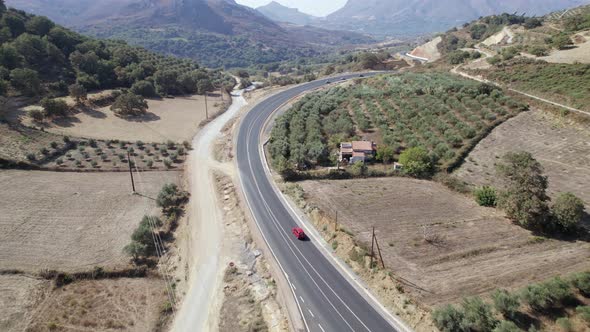 Cinematic curve road landscape. Epic view on the road in mountains, moving cars.